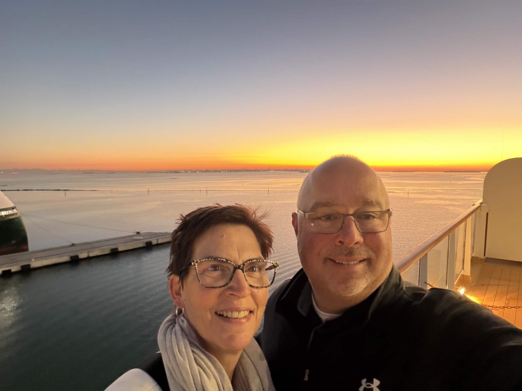 Brian Brennan on a cruise balcony at sunset